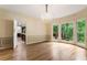 Bright dining room features hardwood floors, chandelier, and bay windows with treed backyard at 3646 Sope Creek Farm Se, Marietta, GA 30067