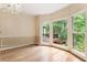 Bright dining room with beautiful chandelier, large windows, hardwood floors, and wainscoting at 3646 Sope Creek Farm Se, Marietta, GA 30067