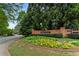 Welcoming brick entrance to the Sibley Forest community, beautifully landscaped with seasonal flowers at 3646 Sope Creek Farm Se, Marietta, GA 30067