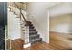 Foyer with hardwood floors and staircase showcasing neutral walls with decorative molding at 3646 Sope Creek Farm Se, Marietta, GA 30067
