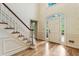 Bright foyer showcasing hardwood floors, a staircase, and an arched doorway at 3646 Sope Creek Farm Se, Marietta, GA 30067