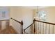 Elegant foyer with a crystal chandelier, hardwood floors, and decorative wallpaper at 3646 Sope Creek Farm Se, Marietta, GA 30067