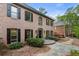 Brick home with black shutters and manicured landscaping leads to front door at 3646 Sope Creek Farm Se, Marietta, GA 30067