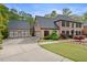 Brick home with an attached three-car garage and landscaped front yard at 3646 Sope Creek Farm Se, Marietta, GA 30067
