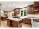 Gourmet kitchen boasts granite countertops, custom wood cabinets, and a bright window at 3646 Sope Creek Farm Se, Marietta, GA 30067