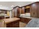 The kitchen features custom wood cabinets, granite countertops, and stainless steel appliances at 3646 Sope Creek Farm Se, Marietta, GA 30067