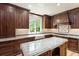Custom wood cabinets, granite countertops, a farmhouse sink, and stainless appliances highlight this kitchen at 3646 Sope Creek Farm Se, Marietta, GA 30067