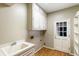Laundry room with white cabinets, sink, and access door at 3646 Sope Creek Farm Se, Marietta, GA 30067