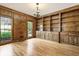 Living room featuring custom wooden built-in bookshelves, hardwood floors, and natural light at 3646 Sope Creek Farm Se, Marietta, GA 30067