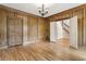 Spacious living room featuring paneled walls, hardwood floors, and decorative light fixture at 3646 Sope Creek Farm Se, Marietta, GA 30067