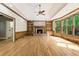 Living room with hardwood floors, fireplace, built-in bookshelves, and large window at 3646 Sope Creek Farm Se, Marietta, GA 30067