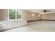 Bright living room with built-in cabinetry underneath a large window offering backyard view at 3646 Sope Creek Farm Se, Marietta, GA 30067