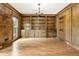 Living room featuring custom wooden built-in bookshelves, hardwood floors, and a window at 3646 Sope Creek Farm Se, Marietta, GA 30067