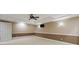 Spacious living area featuring a ceiling fan and lighting fixtures, with a painted accent wall at 3646 Sope Creek Farm Se, Marietta, GA 30067