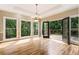 Living room with hardwood floors, chandelier, and doors leading to an outdoor deck area at 3646 Sope Creek Farm Se, Marietta, GA 30067