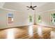 Bright main bedroom featuring hardwood floors, tray ceiling, and multiple windows at 3646 Sope Creek Farm Se, Marietta, GA 30067