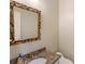 Powder room with marble countertop, gold fixtures, and decorative mirror at 3646 Sope Creek Farm Se, Marietta, GA 30067