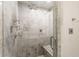 Bathroom shower detailed with marble tile, multiple shower heads, and a glass door at 3646 Sope Creek Farm Se, Marietta, GA 30067