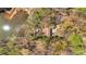Aerial shot of property with a home nestled among lush trees, adjacent to a tranquil pond and a two car drive at 481 Patillo Rd, Stockbridge, GA 30281