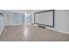 Spacious finished basement with tile flooring, a large wall-mounted screen, and access to the stairs at 481 Patillo Rd, Stockbridge, GA 30281