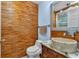 Unique bathroom featuring accent wall of wood, vessel sink, granite counter, and a decorative mirror at 481 Patillo Rd, Stockbridge, GA 30281