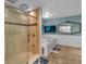 Elegant bathroom featuring a glass-enclosed shower, a soaking tub, and a large mirror in a well-lit space with tile flooring at 481 Patillo Rd, Stockbridge, GA 30281