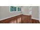 Bright bedroom with hardwood floors and two windows overlooking a wooded area at 481 Patillo Rd, Stockbridge, GA 30281