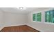 Bright bedroom with hardwood floors and two windows overlooking a wooded area at 481 Patillo Rd, Stockbridge, GA 30281