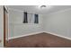 A bedroom with hardwood floors, neutral walls, window with curtains, baseboard trim and a closet with sliding doors at 481 Patillo Rd, Stockbridge, GA 30281