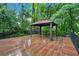 A spacious outdoor deck with a pergola overlooks a lush wooded area, perfect for entertaining at 481 Patillo Rd, Stockbridge, GA 30281