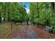 An inviting gated entrance welcomes you into a private retreat surrounded by lush forest views at 481 Patillo Rd, Stockbridge, GA 30281