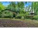 Charming two-story home with a black roof, complemented by lush landscaping and unique architectural elements at 481 Patillo Rd, Stockbridge, GA 30281