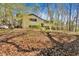 Charming two-story home with an attached deck and car port surrounded by lush, mature trees at 481 Patillo Rd, Stockbridge, GA 30281