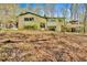 Charming two-story home with an attached deck and car port surrounded by lush, mature trees at 481 Patillo Rd, Stockbridge, GA 30281