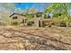 Charming two-story home with an attached deck and car port surrounded by lush, mature trees at 481 Patillo Rd, Stockbridge, GA 30281