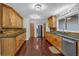 A functional kitchen space with granite counters, wooden cabinets and stainless steel appliances at 481 Patillo Rd, Stockbridge, GA 30281