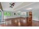 Open-concept living room featuring hardwood floors, modern lighting, and access to the kitchen at 481 Patillo Rd, Stockbridge, GA 30281
