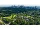 Aerial view of community with golf course, pool, tennis courts and Atlanta skyline at 432 Ansley Walk Ne Ter, Atlanta, GA 30309