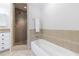 Cozy bathroom featuring a tub with tile surround and a glass shower with a built-in seat at 432 Ansley Walk Ne Ter, Atlanta, GA 30309