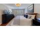 Comfortable bedroom featuring hardwood floors, white shutters, and a modern ceiling fan at 432 Ansley Walk Ne Ter, Atlanta, GA 30309