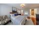 Well-lit bedroom with hardwood floors, chair, and ensuite bathroom and closet access at 432 Ansley Walk Ne Ter, Atlanta, GA 30309