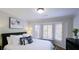 Bright bedroom with white walls, white bedding, and bay window with shutters at 432 Ansley Walk Ne Ter, Atlanta, GA 30309