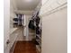 Walk-in closet with wire shelving and hardwood floors at 432 Ansley Walk Ne Ter, Atlanta, GA 30309