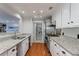 Well-lit kitchen with granite countertops, stainless steel appliances, and access to the utility room at 432 Ansley Walk Ne Ter, Atlanta, GA 30309