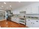 Bright kitchen featuring stainless steel appliances, granite countertops, and convenient access to utility room at 432 Ansley Walk Ne Ter, Atlanta, GA 30309