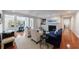 Spacious living room featuring hardwood floors, a fireplace, built-in shelves, and an adjacent sunlit office space at 432 Ansley Walk Ne Ter, Atlanta, GA 30309