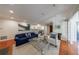 Cozy living room featuring a fireplace, hardwood floors, plush seating, and access to the kitchen at 432 Ansley Walk Ne Ter, Atlanta, GA 30309