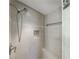 Shower featuring neutral tile surround, built-in seat, and sleek fixtures at 432 Ansley Walk Ne Ter, Atlanta, GA 30309
