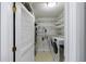 Functional utility room with washer, dryer, storage shelves and access to utility systems at 432 Ansley Walk Ne Ter, Atlanta, GA 30309