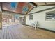 Inviting back porch with wood flooring, skylights, and backyard views with seating at 524 S Holly Springs Rd, Woodstock, GA 30188
